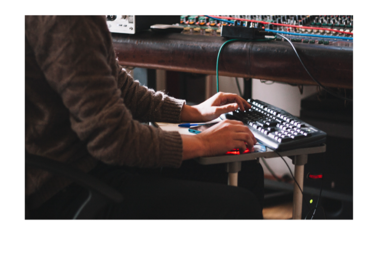 An IMD music director shaping a playlist at a mixing console